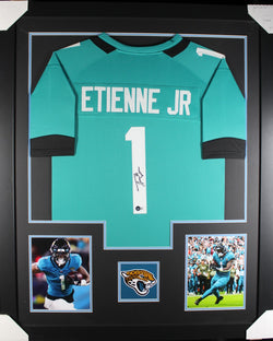 Travis Etienne framed autographed teal jersey